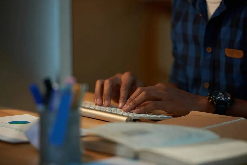 Man typing at a keyboard