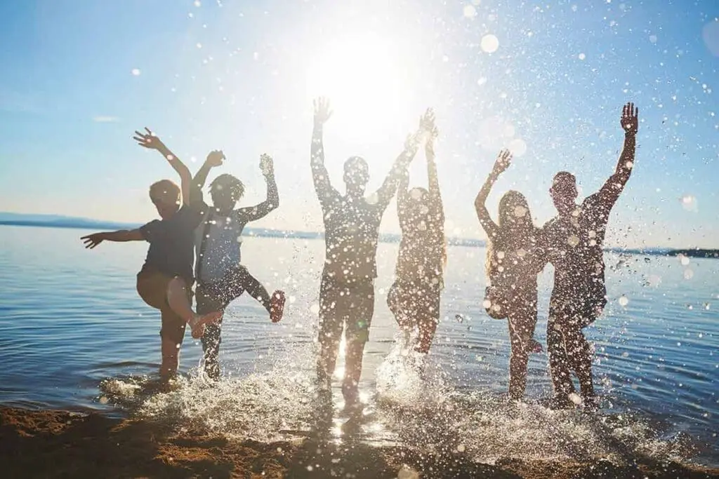 Group of people splashing in the sea